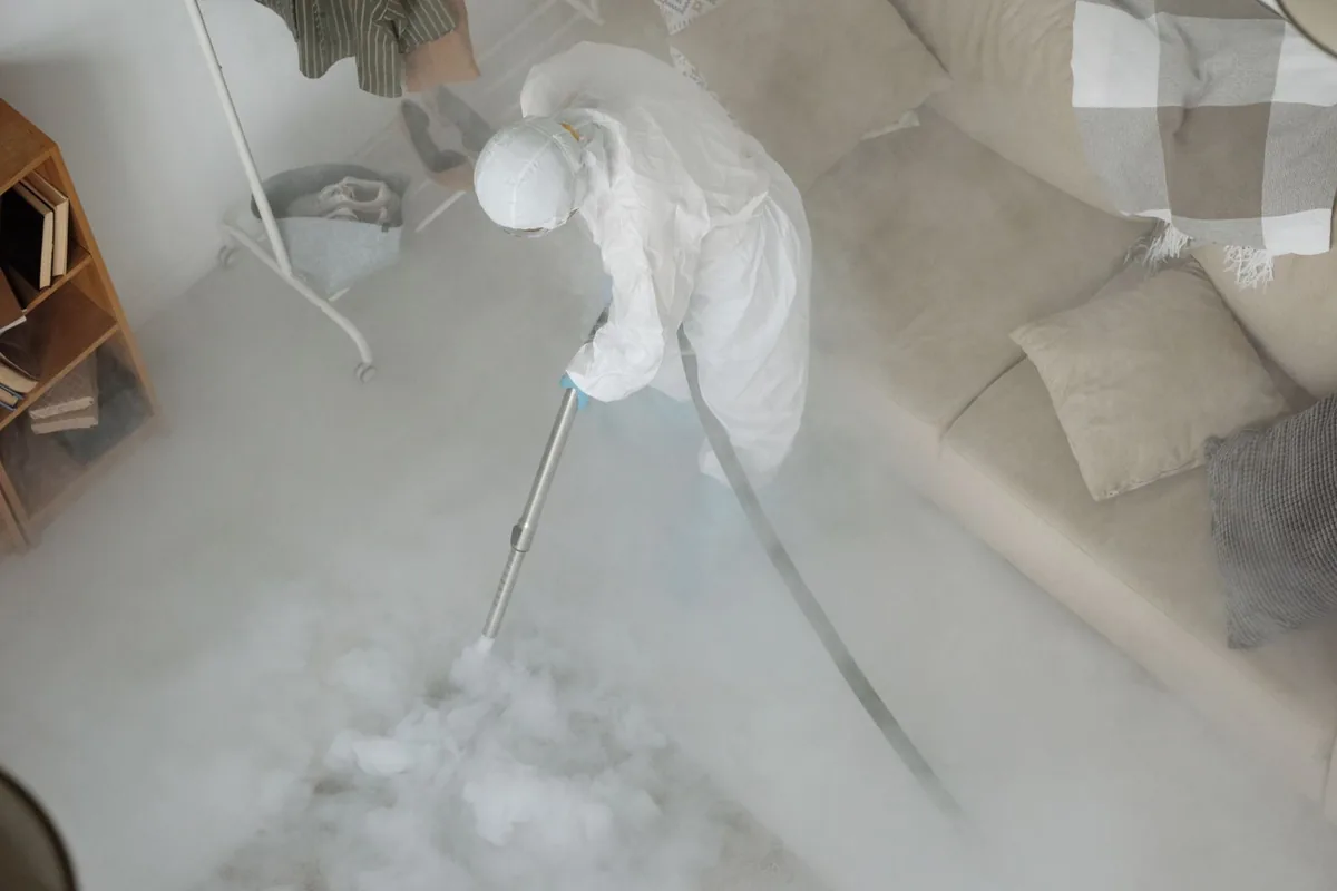 Biohazard cleanup technician in protective equipment, Fresno, TX
